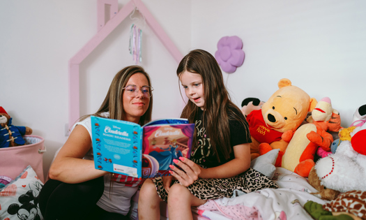 a mother reading to their child in their bromford home