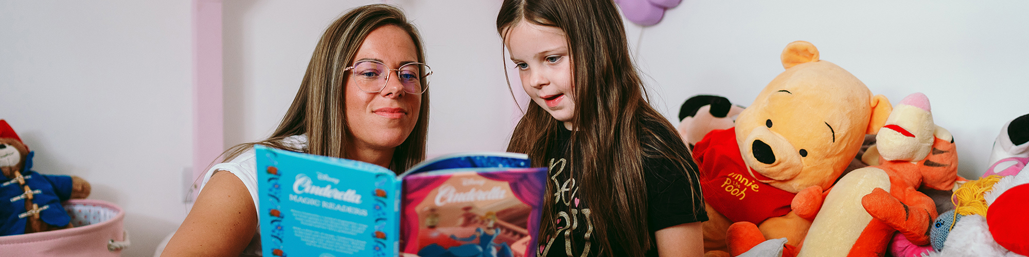 a mother reading to their child in their bromford home