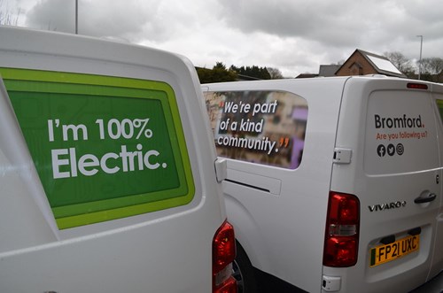 Two of Bromford's new electric vans in a car park