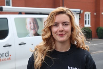 Bromford engineer apprentice stood outside her van.