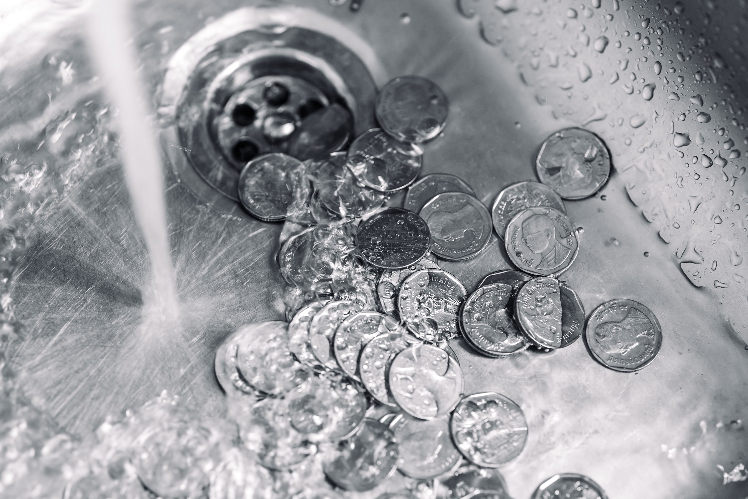 Silver coins being washed in a sink