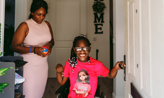 A girl in a wheelchair with her mum 