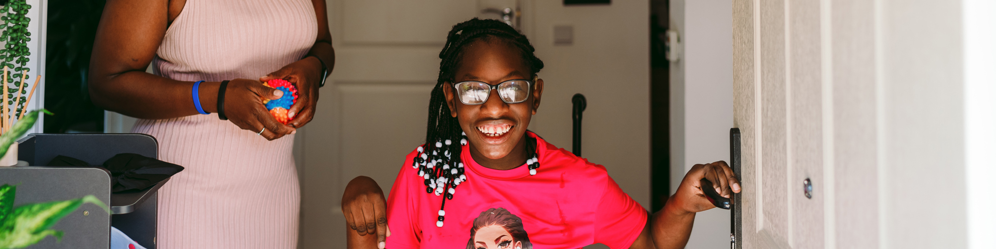 A girl in a wheelchair with her mum 