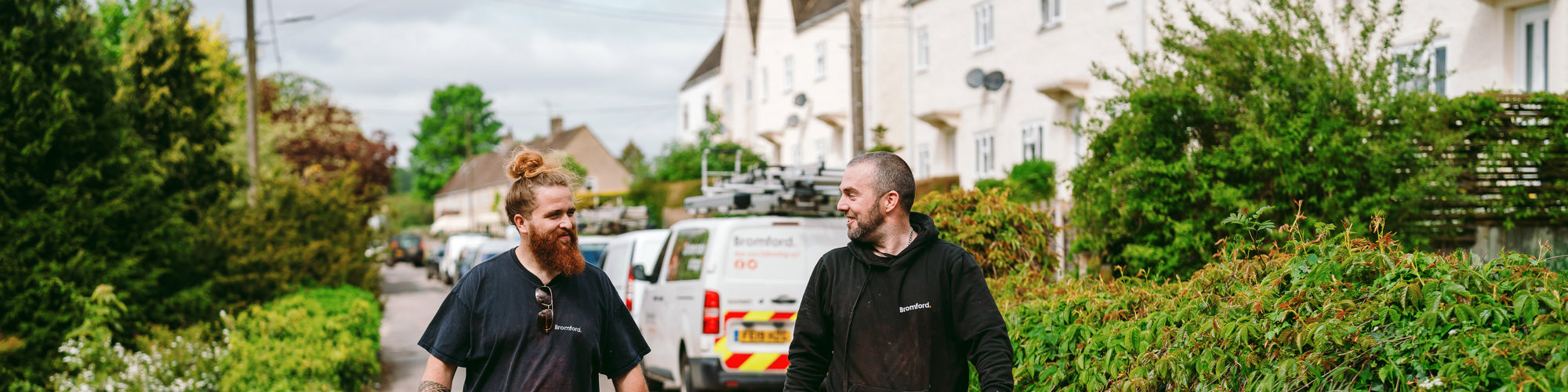 two Bromford colleagues walking on a path 