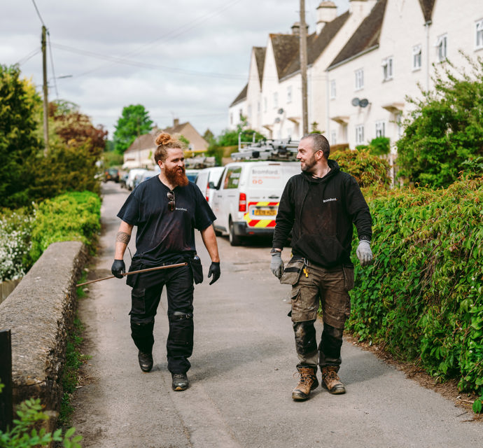 two Bromford colleagues walking on a path
