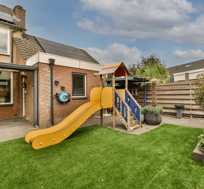 Slide in a garden outside of a home