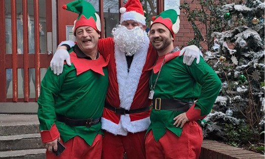 People dressed up as santa and two elves