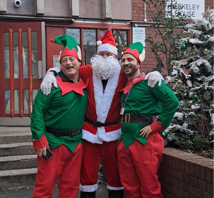 People dressed up as santa and two elves