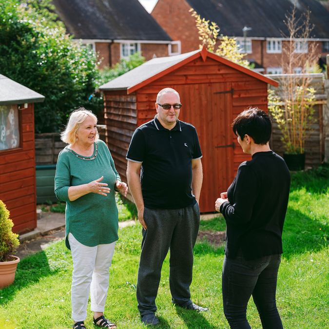 a bromford customer talking to their neighbourhood coach in their garden