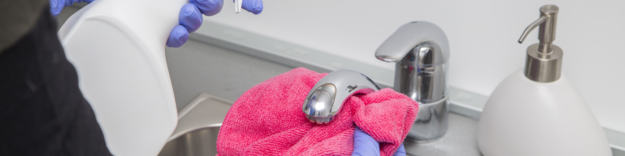 Close up of hands cleaning a tap