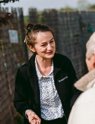 a Bromford colleague and a customer talk with each other