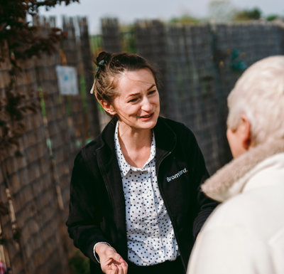 a Bromford colleague and a customer talk with each other