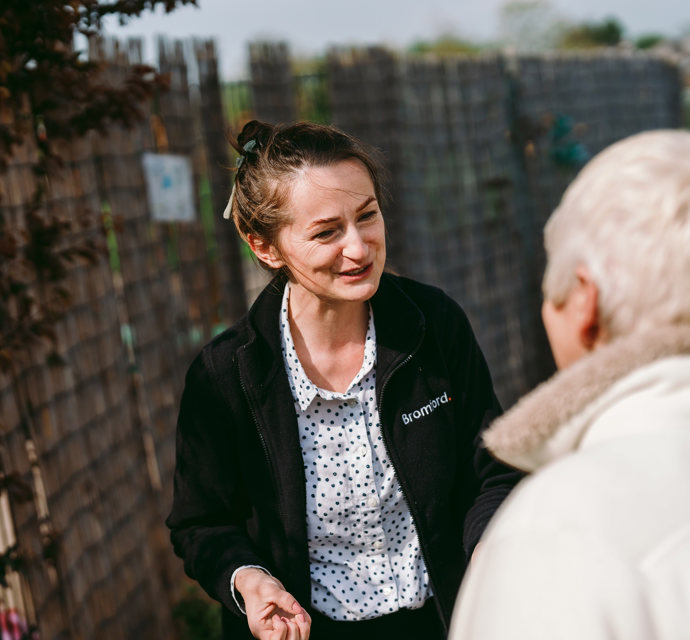 a Bromford colleague and a customer talk with each other