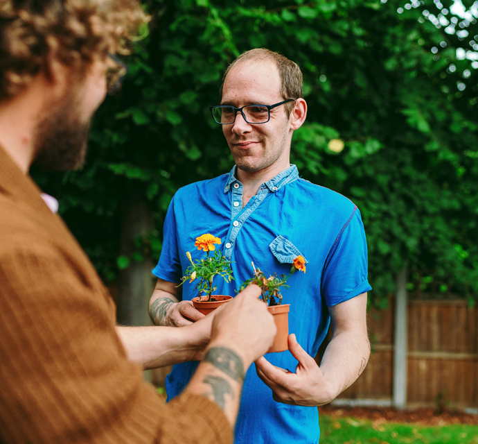 a bromford customer talking to their neighbourhood coach in their garden