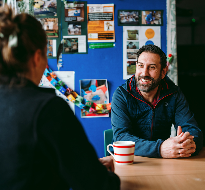 a bromford customer talking to their neighbourhood coach in their kitchen
