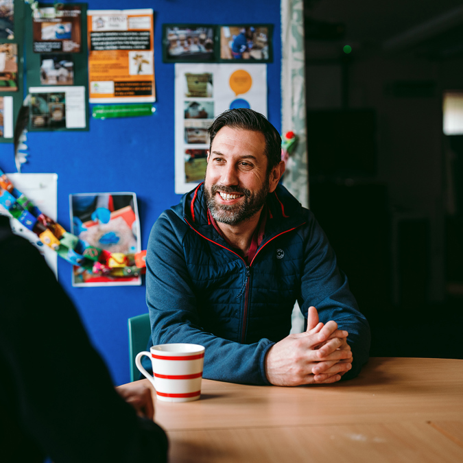 a bromford customer talking to their neighbourhood coach in their kitchen
