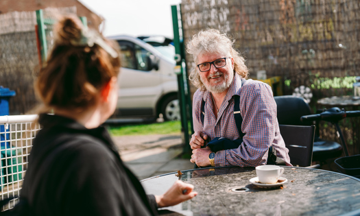 a bromford customer talking to their neighbourhood coach in their garden