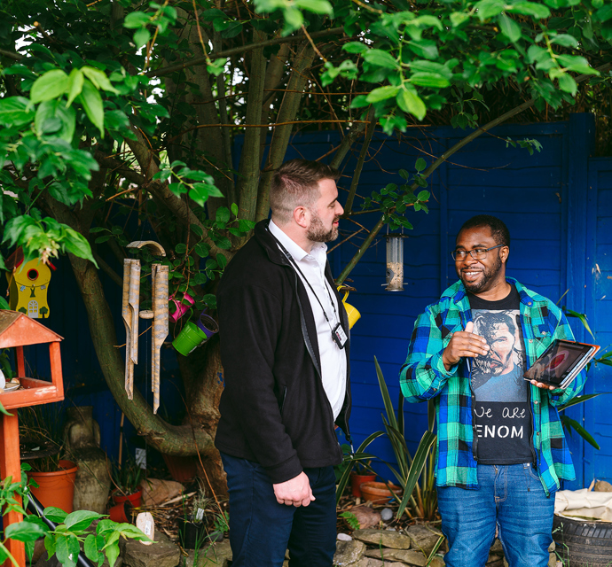 a bromford customer talking to their neighbourhood coach in their garden